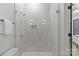 Updated shower with glass door and modern tile at 2312 Selwyn Ave # 502, Charlotte, NC 28207