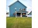 Spacious backyard featuring a covered patio with outdoor seating, perfect for entertaining at 243 Kerri Dawn Ln, Locust, NC 28097
