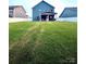 Expansive backyard with lush green grass, ideal for outdoor activities and relaxation at 243 Kerri Dawn Ln, Locust, NC 28097