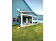 Spacious backyard with a covered patio, furniture, and a well-maintained lawn at 243 Kerri Dawn Ln, Locust, NC 28097