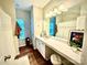 Bright bathroom with white cabinets, a marble countertop, and modern light fixtures at 243 Kerri Dawn Ln, Locust, NC 28097