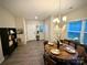 Open-concept dining room adjacent to the entryway, featuring a chandelier and wood-look flooring at 243 Kerri Dawn Ln, Locust, NC 28097
