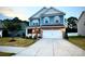 Charming two-story home with a well-manicured lawn, a two-car garage, and a welcoming front porch at 243 Kerri Dawn Ln, Locust, NC 28097