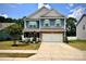 Charming two-story home with a well-manicured lawn, a two-car garage, and a welcoming front porch at 243 Kerri Dawn Ln, Locust, NC 28097