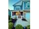 Inviting front porch with rocking chairs and manicured landscaping for a cozy curb appeal at 243 Kerri Dawn Ln, Locust, NC 28097