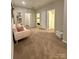 Cozy hallway with carpet flooring, a comfortable couch and access to bedrooms and bathroom at 243 Kerri Dawn Ln, Locust, NC 28097
