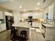 Well-lit kitchen featuring stainless steel appliances, a center island and modern finishes at 243 Kerri Dawn Ln, Locust, NC 28097