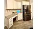 Efficient kitchen space with stainless steel appliances, granite countertops, and a built-in desk area at 243 Kerri Dawn Ln, Locust, NC 28097