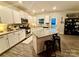 Bright kitchen featuring a center island with bar seating, stainless appliances and white cabinetry at 243 Kerri Dawn Ln, Locust, NC 28097
