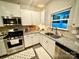 Bright kitchen with stainless steel appliances, granite counters, and a stylish backsplash at 243 Kerri Dawn Ln, Locust, NC 28097