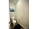 Clean half bathroom with updated flooring, toilet and artwork at 243 Kerri Dawn Ln, Locust, NC 28097