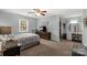 Spacious bedroom with a window, ceiling fan, and an adjacent dressing area at 2460 Prince Dr, Lancaster, SC 29720