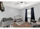 Cozy Bedroom featuring neutral tones, a crib, and a comfy chair by the window at 2460 Prince Dr, Lancaster, SC 29720