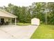 Long driveway leading to the house with a detached storage shed and covered patio area, offering ample parking at 2460 Prince Dr, Lancaster, SC 29720