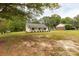 Well-manicured lawn surrounds a lovely single-story home with traditional design elements at 2460 Prince Dr, Lancaster, SC 29720