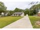Inviting home featuring a long driveway and well-kept yard, blending comfort and style at 2460 Prince Dr, Lancaster, SC 29720