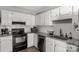 Updated kitchen with white cabinets, modern appliances, and granite countertops at 2460 Prince Dr, Lancaster, SC 29720