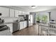 Bright kitchen featuring white cabinets, stainless steel appliances, and a dining area at 2460 Prince Dr, Lancaster, SC 29720