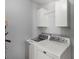 Bright laundry room featuring modern appliances and storage cabinets above the washer and dryer at 2460 Prince Dr, Lancaster, SC 29720