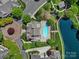 Overhead shot of a pool, lake, landscaping, parking, and multi-Gathering residential buildings at 2959 Bellasera Way, Matthews, NC 28105