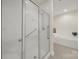 Bathroom featuring walk-in shower with sliding glass doors next to a soaking tub and window at 2959 Bellasera Way, Matthews, NC 28105