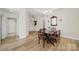 Bright dining room featuring hardwood floors, elegant chandelier, and classic wooden dining set at 2959 Bellasera Way, Matthews, NC 28105