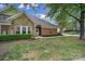 Charming home featuring a stone facade, brick accents, well-maintained lawn, and manicured landscaping at 2959 Bellasera Way, Matthews, NC 28105