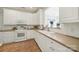 Bright kitchen featuring white cabinetry, modern appliances, and a pass-through window at 2959 Bellasera Way, Matthews, NC 28105