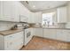 Well-lit kitchen featuring white cabinets, modern appliances, and functional layout at 2959 Bellasera Way, Matthews, NC 28105