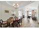 Open floor plan with dining area flowing into living room with fireplace and vaulted ceiling at 2959 Bellasera Way, Matthews, NC 28105