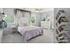 Bright bedroom featuring a decorative bookcase, ceiling fan, and lush garland at 3020 Fallondale Rd, Waxhaw, NC 28173