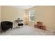 Bedroom with neutral walls, carpet, one window, a small keyboard, and comfortable furniture at 3020 Fallondale Rd, Waxhaw, NC 28173