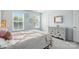 Bedroom featuring two bright windows, soft grey carpet, and a decorative mirror at 3020 Fallondale Rd, Waxhaw, NC 28173