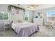 Spacious bedroom featuring a ceiling fan, bright windows, and decorative garland at 3020 Fallondale Rd, Waxhaw, NC 28173