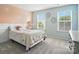 Bright bedroom with neutral carpet, natural light, and walls with designer decorative accents at 3020 Fallondale Rd, Waxhaw, NC 28173