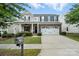 Charming two-story home with a covered front porch, stone accents, and an attached two-car garage at 3020 Fallondale Rd, Waxhaw, NC 28173
