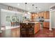 Well-lit kitchen featuring wood cabinets, granite counters, stainless appliances, and a spacious island with seating at 3020 Fallondale Rd, Waxhaw, NC 28173