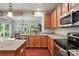 Kitchen featuring granite countertops, stainless steel appliances, and wood cabinets, adjacent to the eat-in area at 3020 Fallondale Rd, Waxhaw, NC 28173