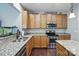 Kitchen featuring granite countertops, stainless steel appliances, and wood cabinets with ample counter space and an open layout at 3020 Fallondale Rd, Waxhaw, NC 28173