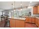 Open layout with kitchen featuring granite countertops, stainless steel appliances, and wood cabinets, adjacent to the dining area at 3020 Fallondale Rd, Waxhaw, NC 28173