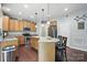Bright kitchen featuring wood cabinets, granite counters, stainless appliances, and a center island with barstool seating at 3020 Fallondale Rd, Waxhaw, NC 28173