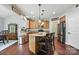 Open kitchen boasts wood cabinets, granite counters, stainless appliances, and a center island with barstool seating at 3020 Fallondale Rd, Waxhaw, NC 28173