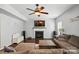 Comfortable living room with a fireplace, ceiling fan, large sectional sofa, and a wall-mounted television at 3020 Fallondale Rd, Waxhaw, NC 28173