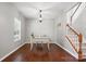 Bright office space featuring a classic desk, chandelier, and access to the staircase at 3020 Fallondale Rd, Waxhaw, NC 28173