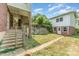 Backyard featuring grass, stairs, and the back of a two-story brick house at 330 S Ellis St, Salisbury, NC 28144