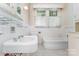 Traditional bathroom with subway tile, pedestal sink, and classic fixtures and window at 330 S Ellis St, Salisbury, NC 28144