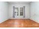 Bedroom with hardwood floors, window and light-green painted walls and trim at 330 S Ellis St, Salisbury, NC 28144