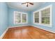 Bright bedroom featuring hardwood floors, neutral walls, and natural light from large windows at 330 S Ellis St, Salisbury, NC 28144