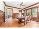 Spacious dining room featuring hardwood floors, wood trim, large windows, and an elegant ceiling fan at 330 S Ellis St, Salisbury, NC 28144