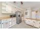 Kitchen with stainless steel refrigerator, light cabinets, laminate countertops, and tile floor at 330 S Ellis St, Salisbury, NC 28144
